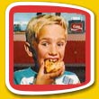 Boy eagerly bites into his pizza