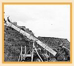 The Bradshaw Bale Booster manufactured by the Lethbridge Iron Works, at work building a stack, 1949.