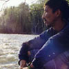 Allistair Janvier, deep in thought as he listens to the rapids in Duscharme River, Saskatchewan.
