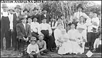 Ukrainian group, Cardiff, Alberta, ca 1910s. Mr. Steve Chaban (2) seated left. Mrs. Teklia Chaban (1) seated 2nd from right holding child.
