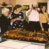 The 100- kg roast pig was presented whole to an appreciative crowd.  Picture includes August Liivam and Marlene Sorensen. 