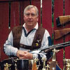 Ken Kotkas Sr. with all of his Trap Shooting Trophy\'s and guns.