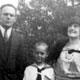 Antonio Rebaudengo with wife Angelina and son Mario, Calgary, Alberta, July 27, 1930. Riverside Hotel, off Langevin bridge, in background.