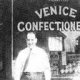 Domenico Chiarello, a former miner, pictured in front of the Venice Confectionery, which he established in Edmonton, with his daughter Francesca in 1949.  Photo courtesy of the family and the Italians Settle in Edmonton Oral History Project and the booklet of the same name.