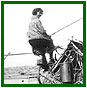 Mrs. Brown on binder on farm Delia.  Glenbow Archives