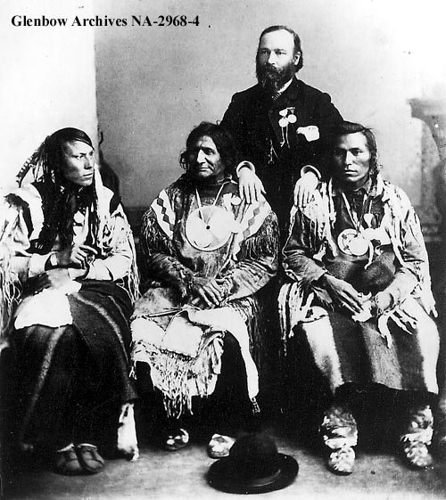 Group of men from the Blackfoot Confederacy. ca. middle 1880s. L-R: One Spot, Blood; Red Crow, Blood; Jean L'Heureux, interpreter; North Axe, Peigan. 