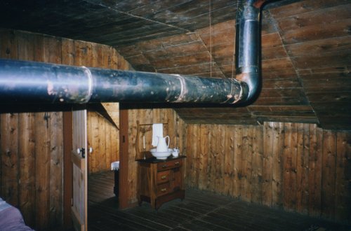 Main Bedroom, Clerks Quarters, at Fort Victoria. Pictured here are the heating pipe, strethced through the room to provide more heat, and a washing stand.