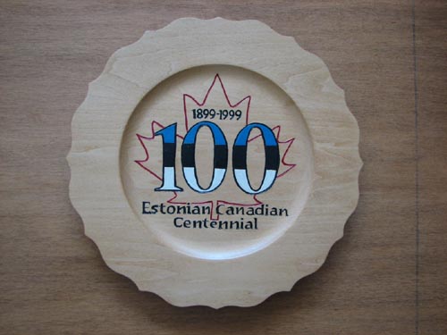 The centenary logo, designed by Janet Matiisen,Calgary, and burned into souvenir plate by Dave Kiil.