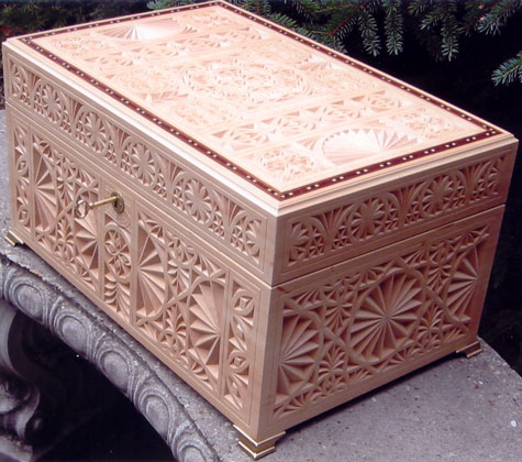 This treasure box was built and chip-carved by Dave Kiil in 2002. The veneer inlay along the perimeter of the lid is made of several tropical woods.