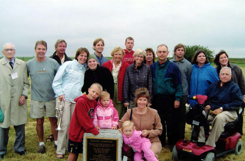 The Kotkas family, one of the first Estonian pioneers to settle in the Barons area, and relatives are pictured at the re-dedicated Barons Cemetery during the Barons Centennial celebration, 2004.