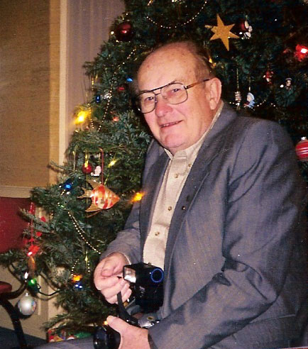 Pictured at Edmonton Society\'s Christmas Party, 2006. Helmut and his camera have attended many Edmonton Estonian Society events and province-wide Centennial and Jaanipev celebrations over the past decades.