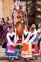 Girls dressed in folk costume carry a statue of the patrona Santa Maria Goretti during her Feast Day Parade.  Photo courtesy of Rudy Cavaliere.