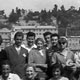 Group of Italian emigrants from Fonzaso, Belluno, Italy, July 1957. Photograph taken before many of the boarded the Cristoforo Colombo for Canada. Photographed in Genova, Italy. L-R back row: unknown; unknown; unknown; Giovanni Giacomin; unknown; unknown; Angelo Giacomin; Valentina Da Barp; unknown; unknown; unknown. Giovanni and Angelo were brothers headed for Calgary, Alberta. Angelo sent for Valentina a year later, they were married in 1958 in Calgary, Alberta. 