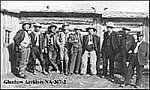 J.J. Bowlen, left, with workers on the Q Ranch