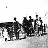 Vehicles are lined up waiting for their mail at the post office on the farm of C. K. Engen of Sundial, Alberta on June 10,  1910.