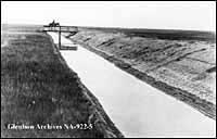 Irrigation canal and cowboy near Stirling, Alberta in 1900.