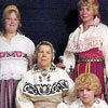 Tiiu Kalev and members of the Koppel family in traditional Estonian folk costumes in 1975  Left to right, standing Myrna and Tiiu Kalev. Sitting Mari Koppel and Lori Kalev.