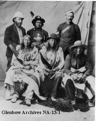 Blackfoot Confederacy chiefs at Fort Macleod, Alberta, 1875. Back Row (L-R): Jean L'Heureaux, Crowfoot's secretary, Red Crow, Blood Chief, Sergeant W. Piercy, North West Mounted Police. Front Row (L-R): Crowfoot, Blackfoot Chief, Eagle Tail, minor chief of the Piegans, Three Bulls, Blackfoot.