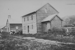 St. Charles Mission, with the rectory in the foreground, and the church to the left. The mission was founded at Dunvegan in 1867, by Father Christophe Tissier, of the Oblates. Photographed in 1899.