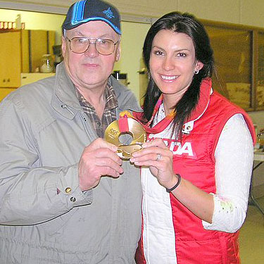 Mellisa Hollingsworth proudly shows her 2006 Olympic Bronze Medal in the Skeleton event to Arnold Mottus. 