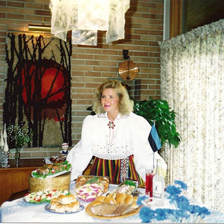 Viivi Rita Piil pictured at a table of festive Estonian foods prepared by Edmonton Estonian Society. The photo was taken by Edmonton Sun for an  article, 1991.